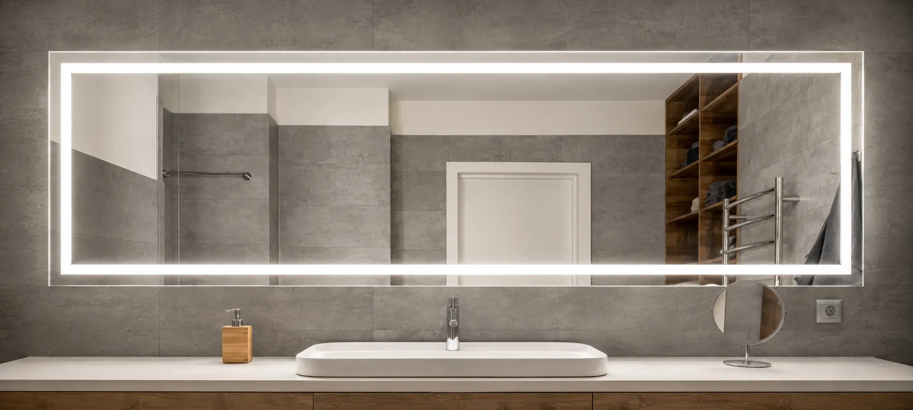 Stylish bathroom featuring a custom lighted mirror and minimalist decor in Coventry.